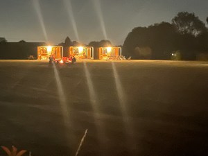Bunkhouses by night with campfire in front